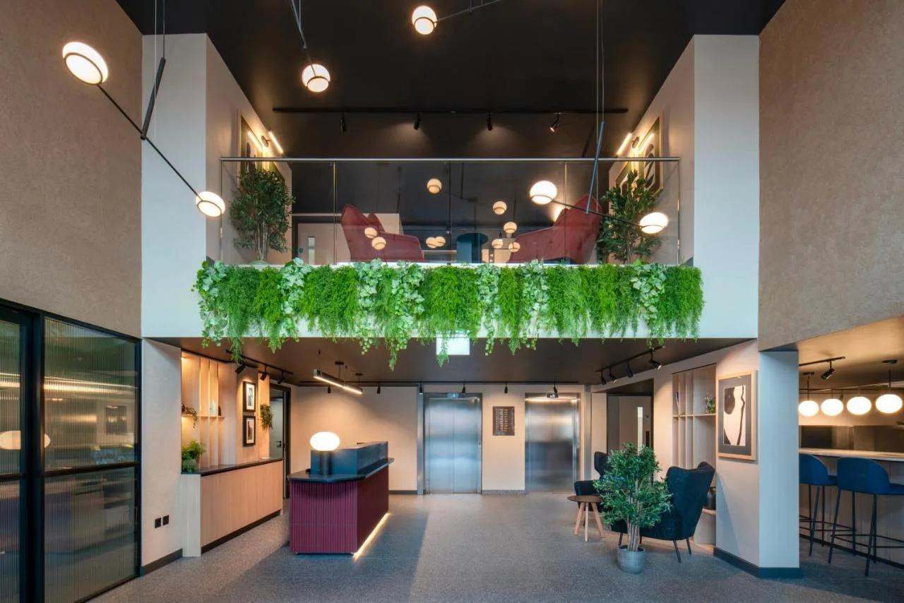 a lobby of a building with plants on the ceiling at Aparthotel Birmingham in Birmingham